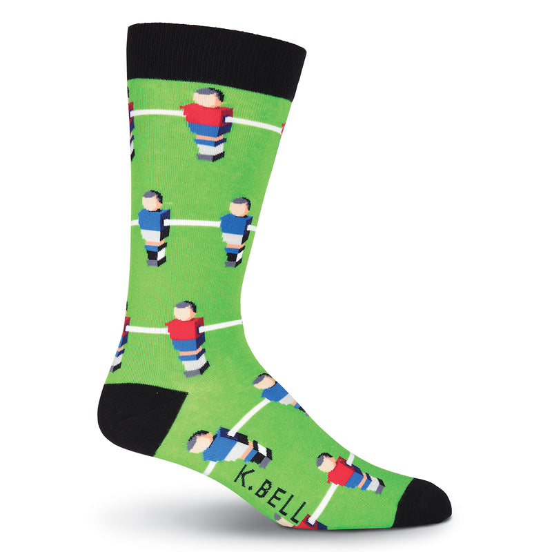 On a Green background with Black Cuffs, Heels and Toes is K Bell Mens Foosball Sock. The Red Team and The Blue Team and set to go with Table Top Soccer. 