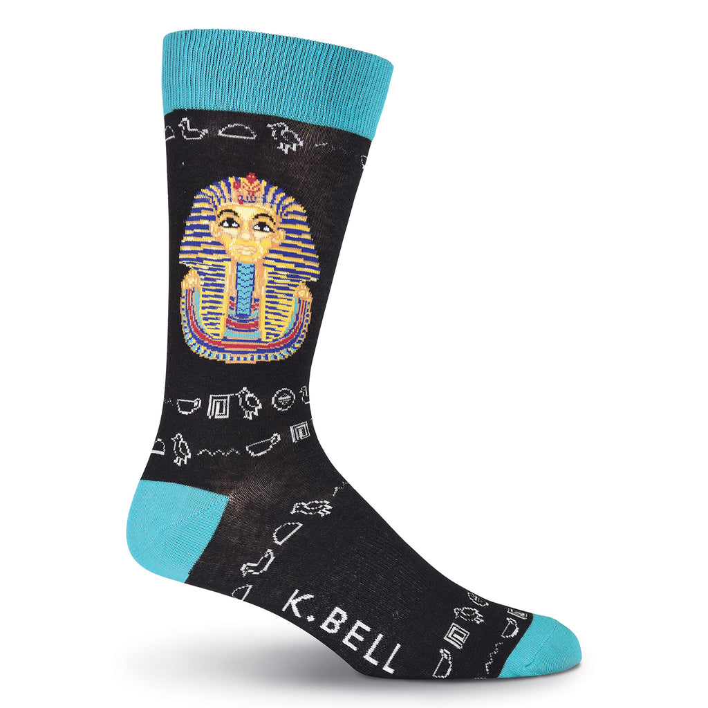 K Bell King Tut Sock begins with a Black background with Viridian Cuffs, Heels and Toes. Hieroglyphs are in Light Grey. King Tut is shown as His Death Mask of Gold, Lapis, Turquoise, Carnelian, Obsidian and Quartz.