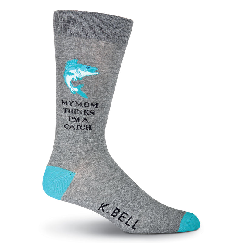 K Bell Mens I'm A Catch Sock begins on a Charcoal Grey background with Viridian Heels and Toes. The Fish Graphic is made with Viridian, Teal and Aquamarine. The words are in Bold Black print that reads, "My Mom Thinks I'm A Catch".