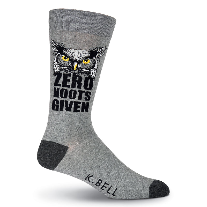 K Bell Mens Zero Hoots Given Sock is a Meme. It starts with Charcoal Heather background and Black Heels and Toes. The Graphic Owl is Dark Grey, Light Grey, Black and Yellow for the Owl's Eyes and Beak. "Zero Hoots Given" is in Bold Black below the Owl.