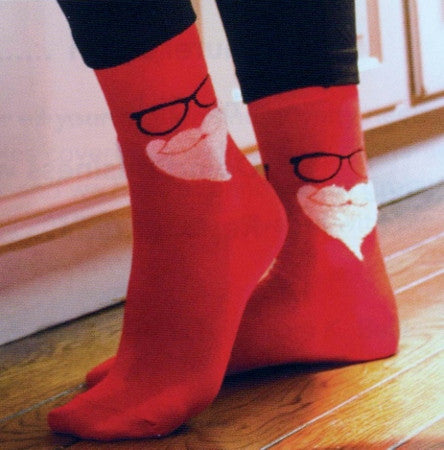 Model Wearing Secret Santa Socks Showing Fuzzy Beard in White Black Glasses and all Red Sock.