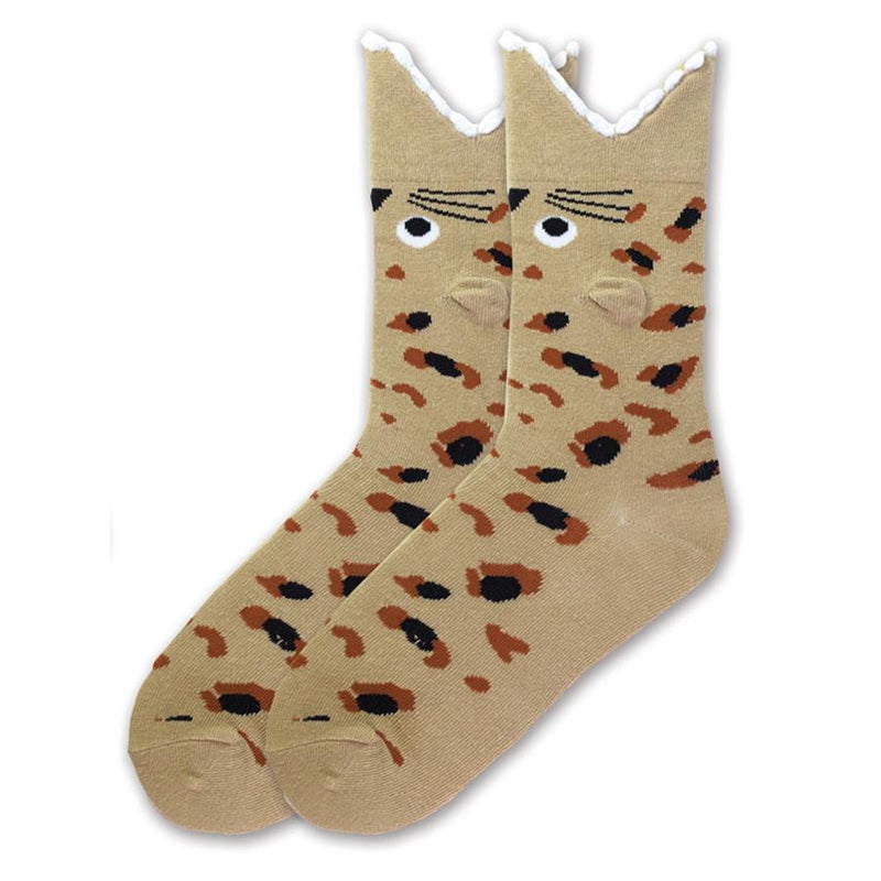 K Bell Wide Mouth Leopard Sock starts with a Sandy Brown background. The spots are Burnt Umber and Black. The Eyes are White and Black. The Teeth are White which is the Cuff.