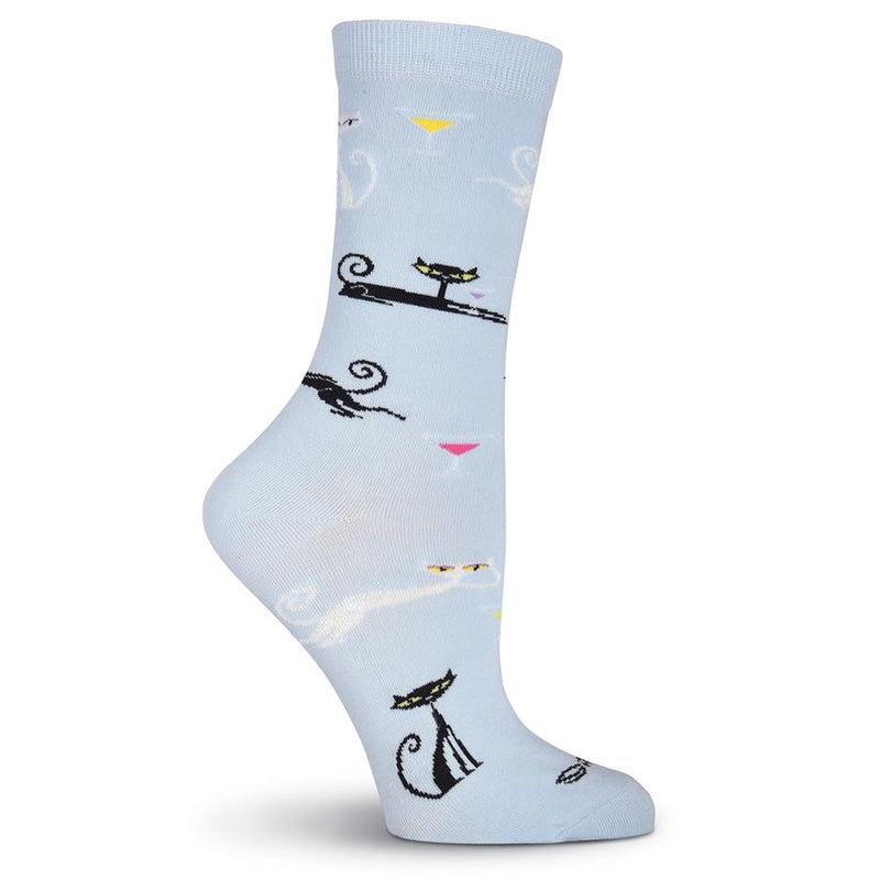K Bell Womens Shag Cats Sock starts on a Light Blue background with White and Black Cats Lounging and Sitting. They are drinking from Martini Glasses. 
