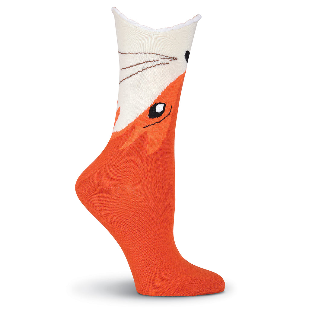 K Bell Womens Wide Mouth Fox Sock starts with a Rust background that makes up the body of the Fox. Moving towards the Top of the Sock you begin to see the Fox's face. His Eye is Black and White, his Nose and Whiskers Black. His Mouth is the Cuff it is open with White Fluffy Teeth.