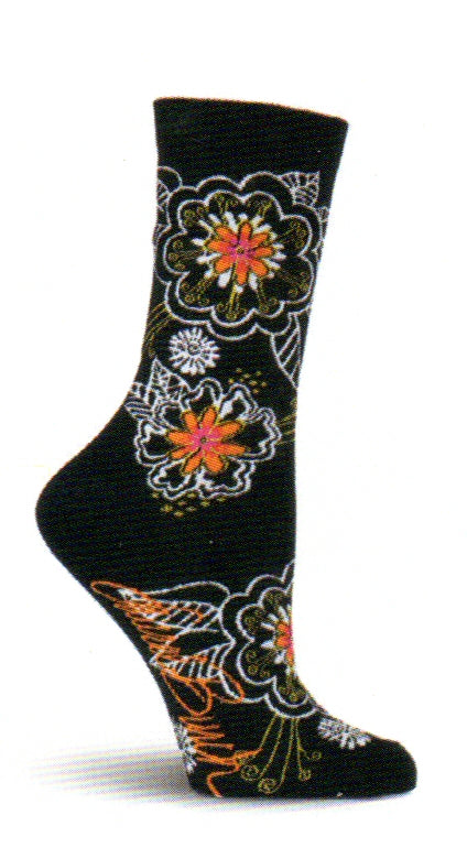 Laurel Burch Black and White Florals Sock begins on a Black background. The Flowers are White, Coquelicot, Crimson and  Gold. They are laid out with Leaves of White.  Gold is used as outlining and parts of the Flowers.  The Flowers are all over the Sock.