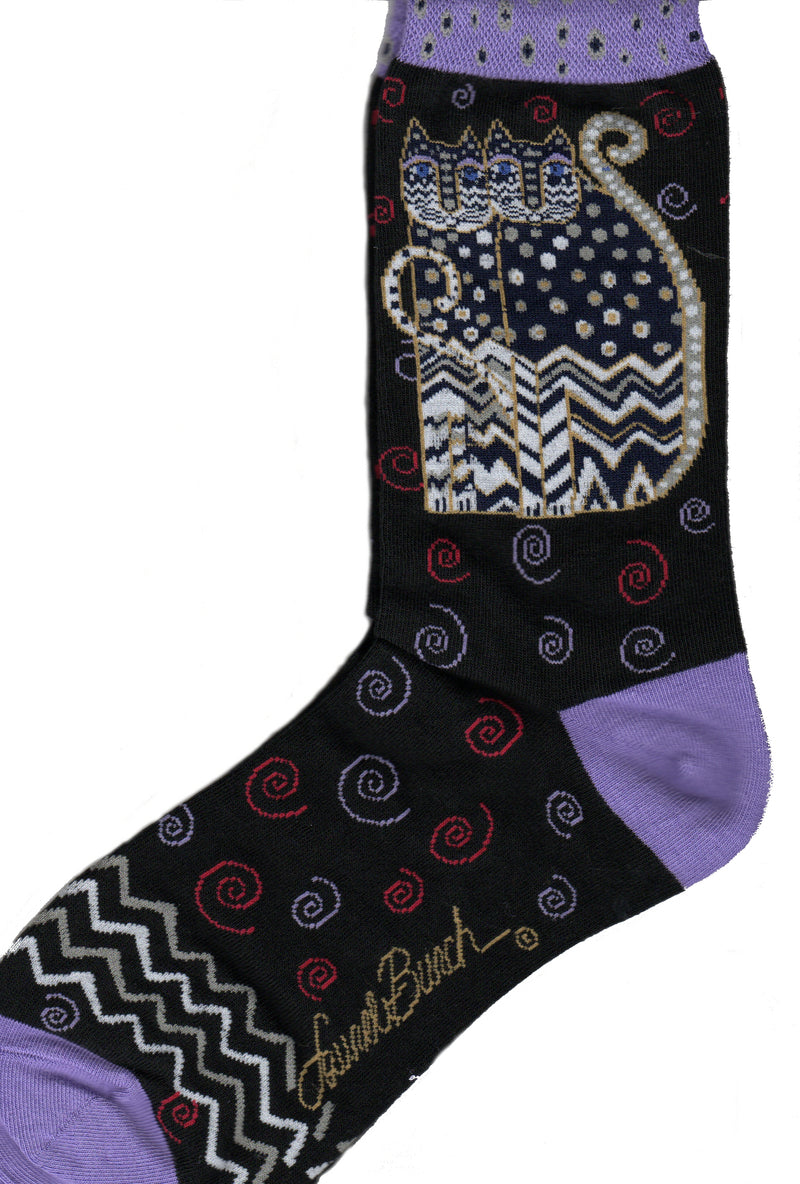 Laurel Burch Polka Dot Gatos Black start with the Black background and Lilac Cuffs, Heels and Toes. The Polka Dot Gatos are Black White and Gold with Indigo Eyes. Polka Dots are on the Gatos Face and Body at the top. Zig Zags are at the bottom of the Face and the Body.