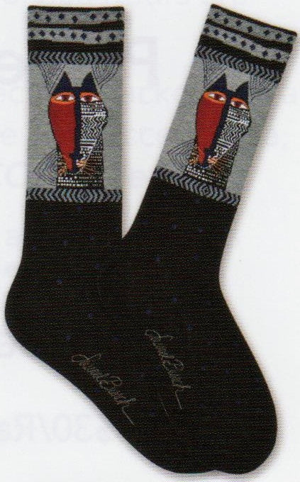 Laurel Burch Mens Native Cat Sock is Black with Dots at the foot and the Welt is the Cat face looking like a Native Mask. One Side all Red the other side is Black with symbols.