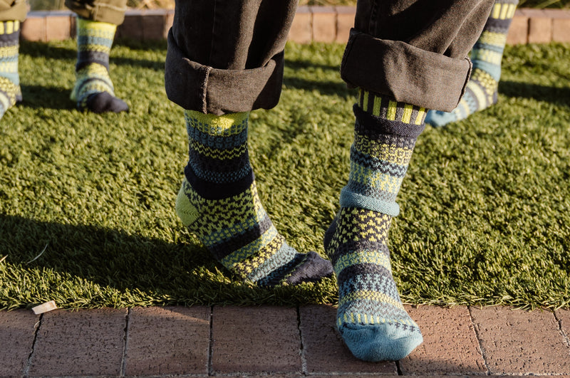Solmate Adult Crew Lemongrass Sock on Models on lawn grass. 