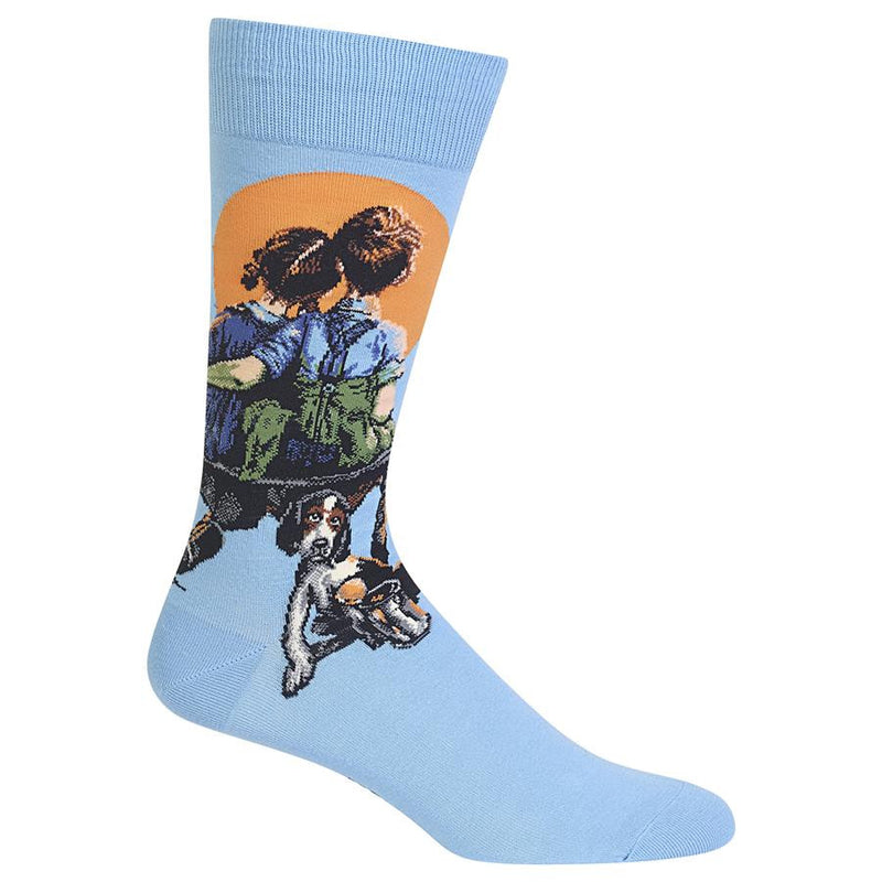 Hot Sox Mens Little Spooners Sock have about a two inch Cuff and then on the Sky Blue background starts the painting. An Orange Sun or Moon depending on which title you like is big in the night sky. The boy and girl are watching it on a makeshift bench. They are spooning together. The dog waits patiently for something to do.