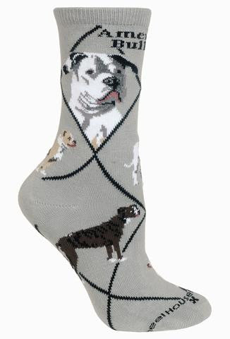 Wheel House Designs American Bulldog on Grey has Black Lines that make diamonds over the sock. Below the Cuff reads, American Bulldog in bold Black letters. Then come the Portraits a front and side profile. The Poses show White and Tan, Brindle and Tan and White colored American Bulldogs.