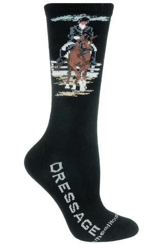 Wheel House Designs Dressage Sock starts on a Black background. Dressage is spelled out in Grey Bold Print on both sides of the Foot. The Rider and Horse are Decked out in Finery. This is an event where the Rider is in Formal Wear. The Horse is Chestnut and Black Mane is Braided. 