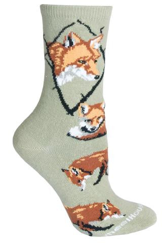 Wheel House Designs Fox on Stone Sock has a Portrait of a Red Fox in a Diamond made of Black Tree Branches. The Colors of Sienna and Rust, White and Light Grey with Black make up the Features of all the Foxes on this Sock. The Poses are of one Laying tightly in a circle and the others Nose to ground on the scent for food.