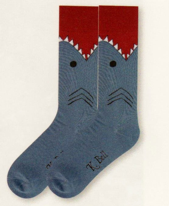 A picture of K Bell Mens Shark Sock starts with a Maroon Mouth, White with Black for Teeth. Black for Eyes and Gills. The rest of the Shark's Body is Slate Blue to the Toes.