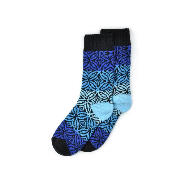 Side Kick Adult Crew Rosemont Sapphire Sock is a graphic of a 5 Petal Flower and Diamonds. The Colors are Sapphire, Light Blue, Light Teal, and Black.