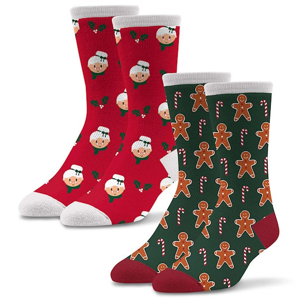 This 2 Pair Pack from Socktastic starts with Mrs. Clause. On all Red background with White Cuffs, Heels and Toes. Mrs. Clause has her White Hair up in a Bun. Wearing Green trim around her Hair and Neck. Holy is also around the Sock. Gingerbread Man Sock is Green with  a Dark Red Heel and Toes and White Cuffs. The Gingerbread Man is Brown and has Red and White Candy Canes all around him.