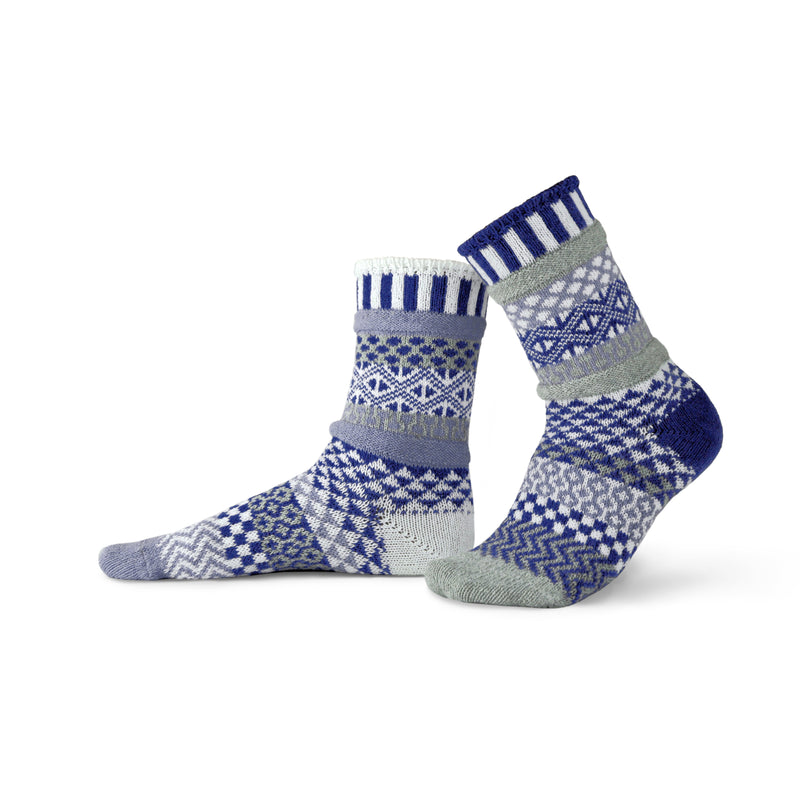 Solmate Adult Crew Glacier Sock is a Sock has Colors of Royal Blue, Blue-Grey, Dark Grey, and White. All these are in the Ice and Water and the Rocks and Mountains. 