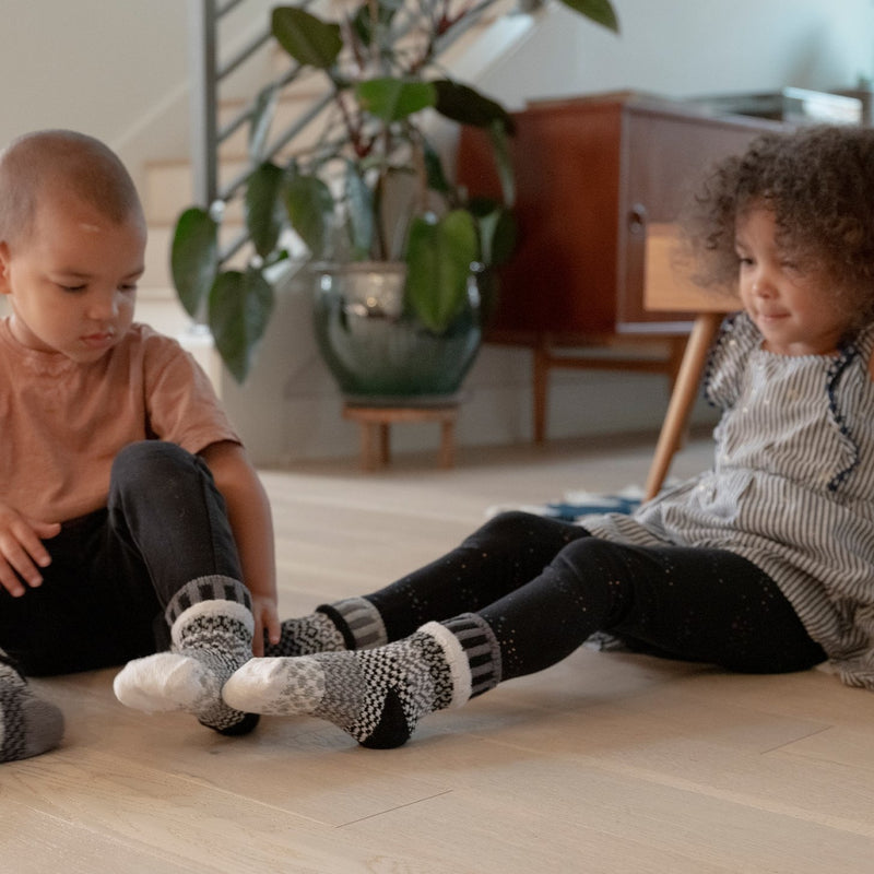 Solmate Kids Crew Moonlight Socks on Girl and Boy Models showing sizes.