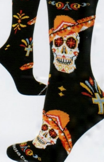 Wheel House Designs Day of the Dead Sombrero Sock starts on a Black background. With Sugar Skulls and wearing colorful Orange Sombreros. This Sock also has colorful Bunting and Flowers around the sock.