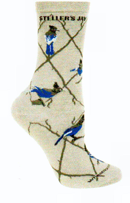 Wheel House Designs Steller's Jay starts with a Grey background and an Argyle Lattice Vine of Medium Grey. The Steller's Jay is in the top Diamond after the Words Steller's Jay. Then over the Lattice on bigger branches of the tree. The main colors of the Steller's Jay are Black including the Crest, Azure and Blue.