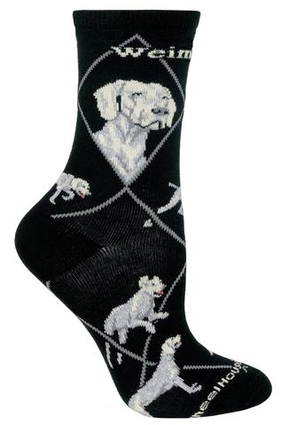 Wheel House Designs Weimaraner on Black Sock starts off on Black with an Argyle Medium Taupe Grey Diamond Lines. The Profiles of the Weimaraners are below the name of the Dog. The Colors in the Profiles and Poses are Medium Taupe Grey, Ecru, Light Grey and Rose. There are two different Profiles and 4 Poses on the sock.