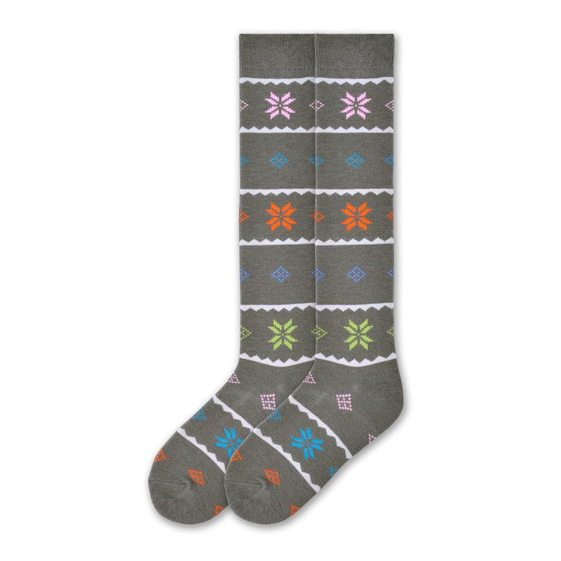 K Bell Womens Nordic Snowflake Knee High is made with a Wool Blend. The background color is Steel Grey. Cream Waves break up the sock into blocks. The Snowflakes are a Nordic design style. So are the Diamond and Squares in the patterns. Colors are Bright Pink, Cyan, Orange and Lime Green. Another row is Cerulean.