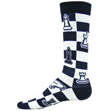 Wright Avenue Mens Chess Sock starts on a Black and White Chess Board. The Cuffs, Heels and Toes are Black. Pieces on the Board are Black and White. There are Bishops, Rooks, Pawns and more.