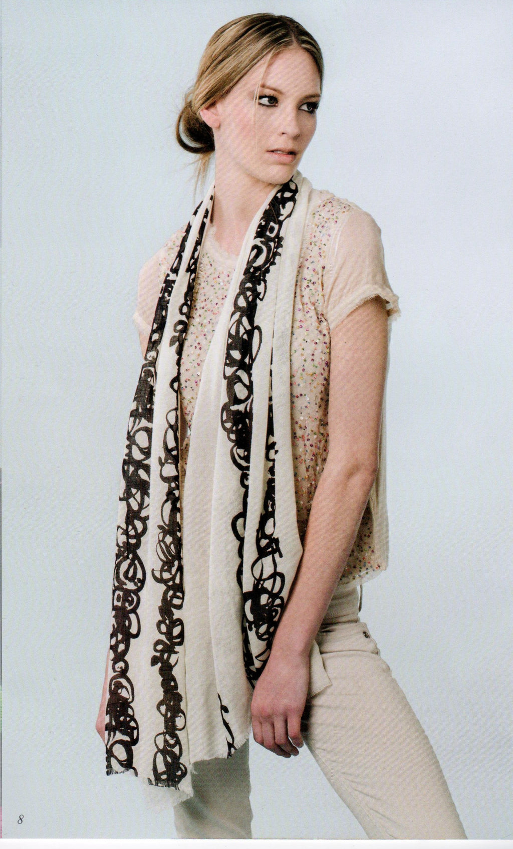 Model wearing Zazou Calligraphy Scarf draped across her neck and down her front.